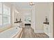 This bathroom has an elegant soaking tub, tile floors, and a stone countertop vanity at 15909 Heath Aster Way, Davidson, NC 28036