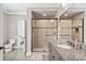 Bathroom boasts a spacious shower with glass enclosure, granite countertop, and wood cabinets at 15909 Heath Aster Way, Davidson, NC 28036