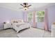 Bright bedroom with natural light, white bed and bedside tables, and pink accents at 15909 Heath Aster Way, Davidson, NC 28036