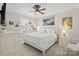 Bright bedroom features a bed with white bedding, artwork, and natural light from the window at 15909 Heath Aster Way, Davidson, NC 28036