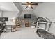 Spacious bonus room features a treadmill, desk, and hanging chair, perfect for fitness or relaxation at 15909 Heath Aster Way, Davidson, NC 28036