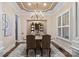 Elegant dining room features a decorative chandelier, window shutters, and built-in display cabinet at 15909 Heath Aster Way, Davidson, NC 28036
