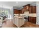 Gourmet kitchen featuring granite countertops, hardwood floors and large island at 15909 Heath Aster Way, Davidson, NC 28036