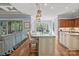 Spacious kitchen with island, granite counters, stainless appliances, and hardwood floors with view into living and dining rooms at 15909 Heath Aster Way, Davidson, NC 28036