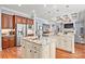 Spacious kitchen with double islands, stainless appliances, granite counters, and hardwood floors at 15909 Heath Aster Way, Davidson, NC 28036