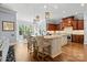 Gourmet kitchen featuring double islands, granite counters, stainless appliances, and hardwood floors at 15909 Heath Aster Way, Davidson, NC 28036