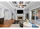 Spacious living room with coffered ceiling, fireplace, and sliding glass doors to the outdoor patio at 15909 Heath Aster Way, Davidson, NC 28036