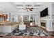 Open concept living room featuring a fireplace, coffered ceilings, and seamless flow to the bar area at 15909 Heath Aster Way, Davidson, NC 28036
