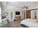 This main bedroom has wood floors, and a tray ceiling with an ensuite bathroom at 15909 Heath Aster Way, Davidson, NC 28036
