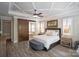 This main bedroom features an ensuite bathroom with a barn door and lots of natural light at 15909 Heath Aster Way, Davidson, NC 28036