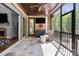 Outdoor living on the screened porch featuring a television and comfortable seating at 15909 Heath Aster Way, Davidson, NC 28036