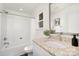 Well-lit bathroom with granite countertop, modern fixtures, and a shower-tub combo at 1841 Bear St, Charlotte, NC 28213