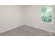 Bright bedroom with plush carpeting, natural light, and neutral wall color at 1841 Bear St, Charlotte, NC 28213