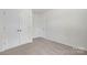 Cozy bedroom features a double door closet, soft carpet and neutral colors at 1841 Bear St, Charlotte, NC 28213