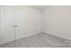Cozy bedroom features a double door closet, soft carpet and neutral colors at 1841 Bear St, Charlotte, NC 28213