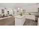 Open concept kitchen featuring granite countertops, white cabinetry, and access to the living room at 1841 Bear St, Charlotte, NC 28213