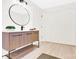 Modern bathroom with a wooden vanity, black hardware, and a round mirror at 188 Bailey Rd, Mooresville, NC 28117