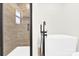 Contemporary bathroom with a glass-enclosed shower and a freestanding white bathtub with black fixtures at 188 Bailey Rd, Mooresville, NC 28117