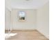 Inviting bedroom with laminate floors, a closet with a sliding mirror door, and a window at 188 Bailey Rd, Mooresville, NC 28117
