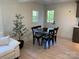 Open-concept dining area with a square table and chairs, next to the living room at 188 Bailey Rd, Mooresville, NC 28117