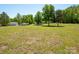 Sprawling backyard with mature trees offers ample space for recreation and outdoor activities at 2008 Faulkner Rd, Clover, SC 29710