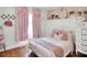 Charming bedroom features pink curtains and matching pillows on the metal frame bed at 2008 Faulkner Rd, Clover, SC 29710