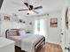 Cozy bedroom with hardwood floors, a black metal bed frame, and white curtains at 2008 Faulkner Rd, Clover, SC 29710
