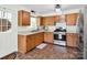 Functional kitchen with stainless steel appliances, wood cabinets, and tile flooring at 2008 Faulkner Rd, Clover, SC 29710