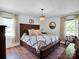 Spacious main bedroom with hardwood floors, large bed, and ample natural light from two windows at 2008 Faulkner Rd, Clover, SC 29710