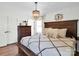 Well-lit main bedroom featuring hardwood floors, a wooden bed frame and white walls at 2008 Faulkner Rd, Clover, SC 29710