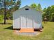 Durable outbuilding with double doors provides secure storage and easy access to backyard at 2008 Faulkner Rd, Clover, SC 29710