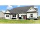 Spacious backyard featuring a well-maintained lawn, patio with outdoor seating and grill at 2119 Smith Rd, Clover, SC 29710