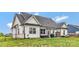 Expansive backyard featuring a well-maintained lawn, black fence, and patio with outdoor seating and grill at 2119 Smith Rd, Clover, SC 29710