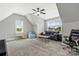 Upstairs bonus room with a ceiling fan, comfortable seating, and lots of natural light at 2119 Smith Rd, Clover, SC 29710