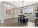 Well-lit dining area featuring hardwood floors, modern pendant lighting, and a view of the outdoors, perfect for Gathering meals at 2119 Smith Rd, Clover, SC 29710