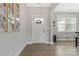 Bright entryway with hardwood floors, a white front door, and decorative wall art, creating a welcoming and stylish foyer at 2119 Smith Rd, Clover, SC 29710