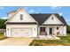 Charming two-story home with white siding, covered porch, and well-manicured lawn. Perfect for curb appeal and relaxed outdoor living at 2119 Smith Rd, Clover, SC 29710