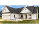 Lovely two-story house with white siding, a welcoming porch swing, and a manicured lawn, creating a cozy and inviting atmosphere at 2119 Smith Rd, Clover, SC 29710