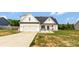 Inviting two-story home featuring a well-maintained lawn, covered porch, and attached garage, showcasing its attractive facade at 2119 Smith Rd, Clover, SC 29710