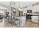 Bright kitchen with white cabinets, stainless steel appliances, and a breakfast bar, offering a stylish and functional space at 2119 Smith Rd, Clover, SC 29710