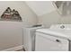 Well-equipped laundry room with modern washer and dryer and wall-mounted mountain-shaped shelf at 2119 Smith Rd, Clover, SC 29710