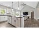 Open-concept living room features a vaulted ceiling, an island kitchen, and wood-look floors at 2119 Smith Rd, Clover, SC 29710