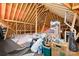 Unfinished attic space, revealing wooden beams, storage boxes, and insulation; great storage potential at 2334 Sylvia Ct, Denver, NC 28037