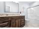Bathroom with modern fixtures, granite countertop, dark wood cabinets, and a separate tub at 2334 Sylvia Ct, Denver, NC 28037