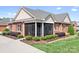 A charming red brick home with a screened-in porch and well-manicured landscaping at 2334 Sylvia Ct, Denver, NC 28037