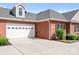 A spacious two-car garage on a red brick home, providing ample parking and storage at 2334 Sylvia Ct, Denver, NC 28037