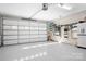 Spacious garage with epoxy flooring, a large garage door, and organized storage racks at 2334 Sylvia Ct, Denver, NC 28037