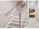 Well-lit staircase featuring hardwood steps, white risers, and a wooden handrail at 2334 Sylvia Ct, Denver, NC 28037