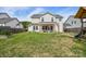 Expansive backyard with lush green grass, a wooden fence, and a covered patio perfect for outdoor entertaining at 235 Whispering Hills Dr, Locust, NC 28097