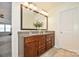 Bathroom featuring a double sink vanity with granite countertops, a large mirror, and stylish fixtures at 235 Whispering Hills Dr, Locust, NC 28097